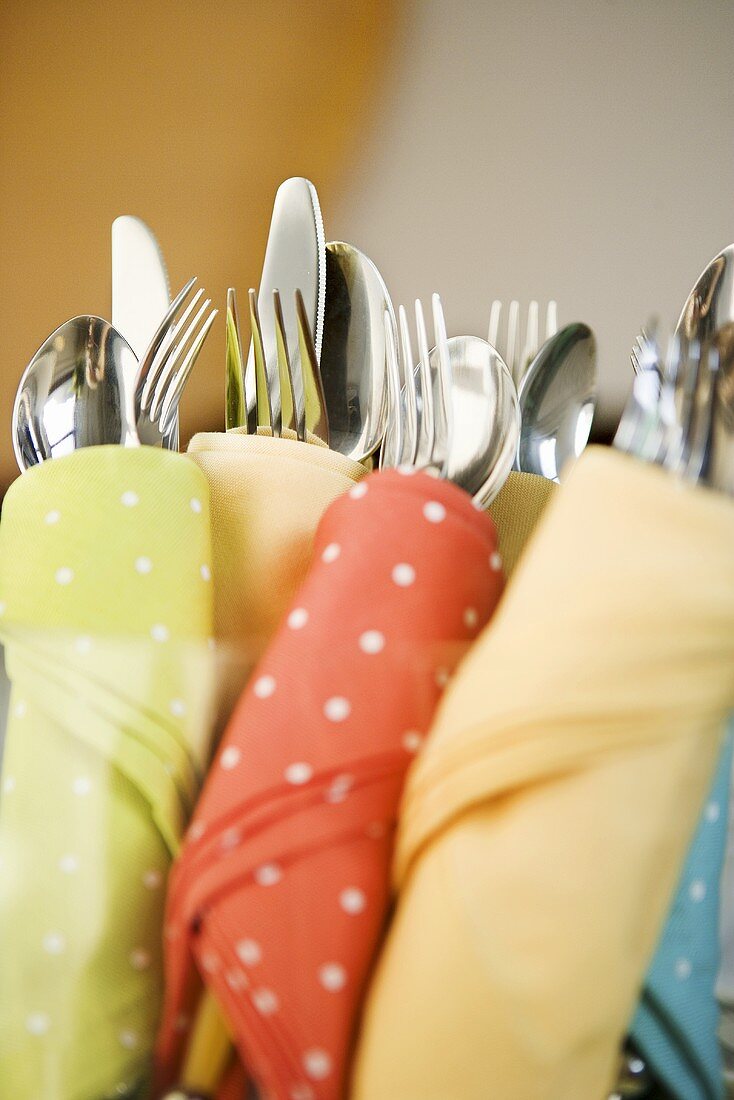 Silverware Wrapped in Assorted Cloth Napkins