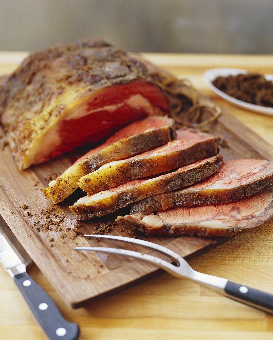 Partially Sliced Beef Roast on Cutting Board
