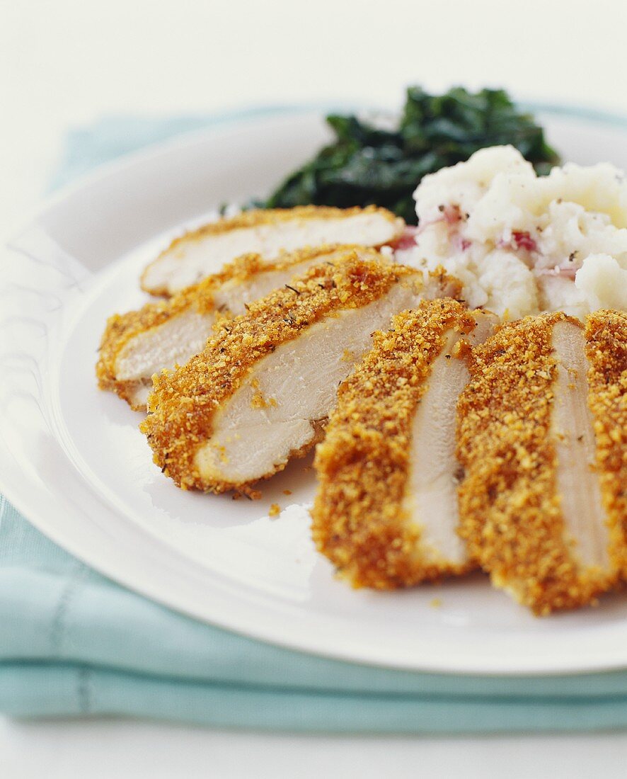Sliced Breaded Chicken with Mashed Potatoes and Greens