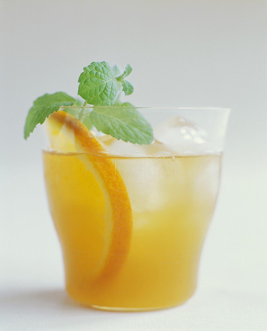 Orange Drink with Mint Garnish