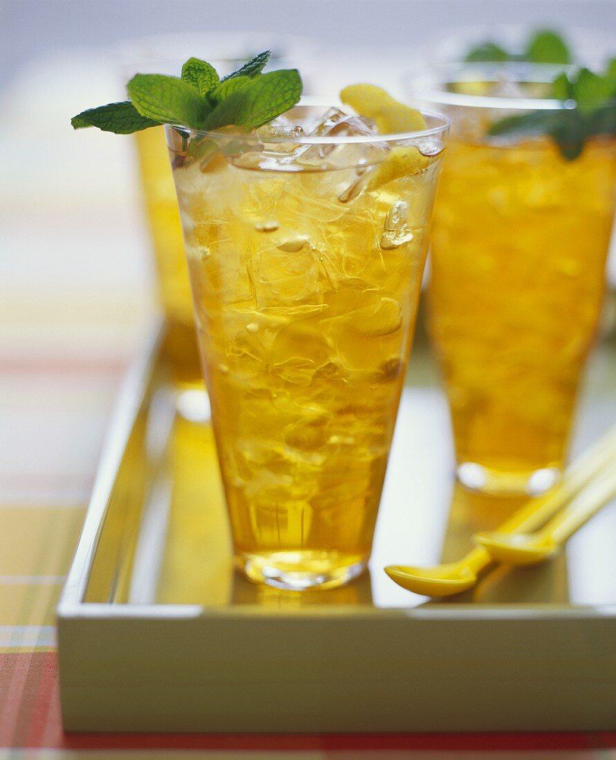 Three Tall Glasses of Ice Tea with Mint Garnish