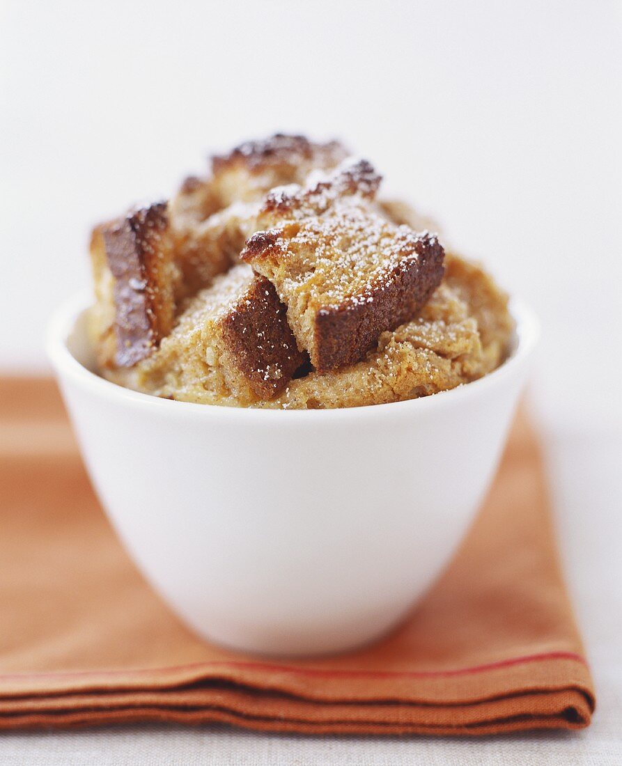Small Bowl of Bread Pudding Dusted with Powdered Sugar