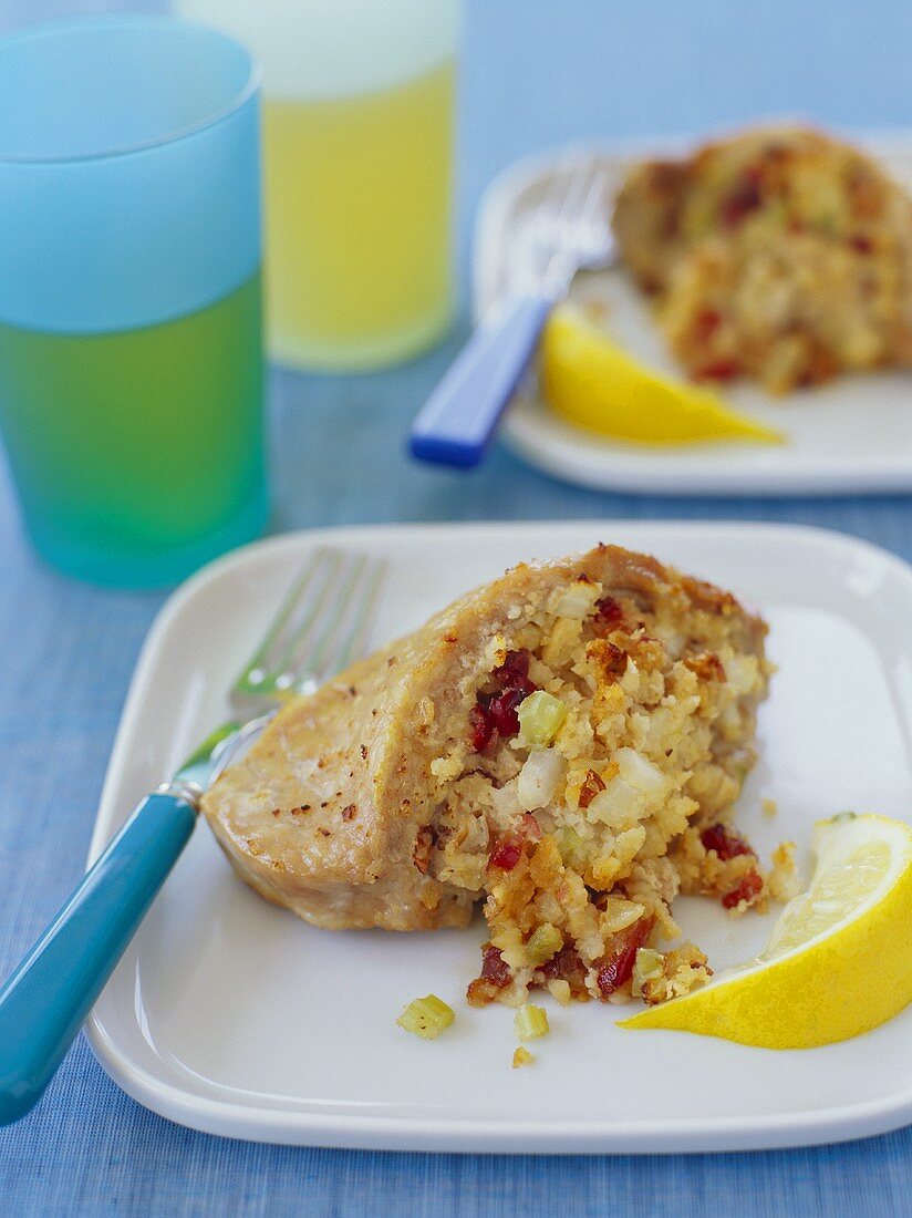 Stuffed Pork Chop with Lemon Wedge on a Plate