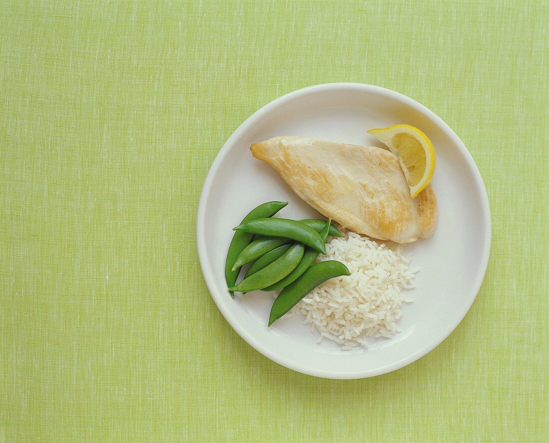 Plain Chicken Breast with White Rice and Snap Peas on a Plate