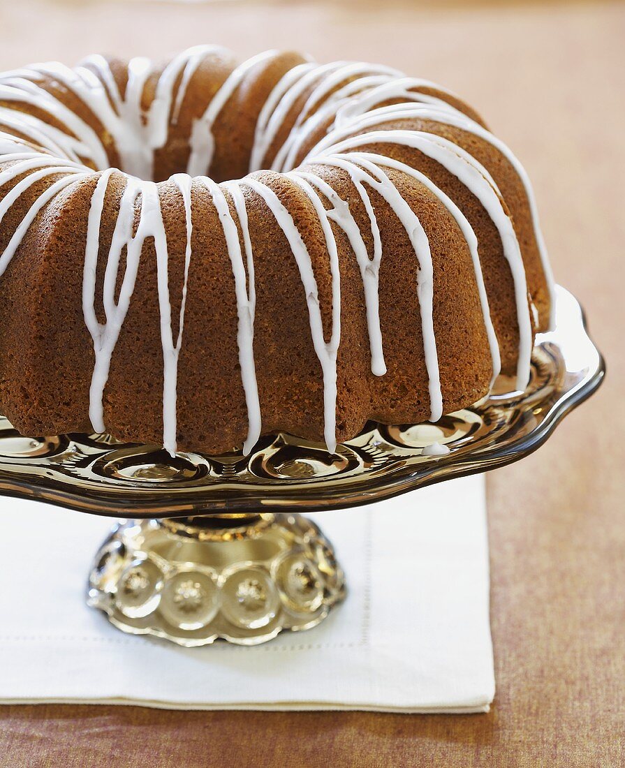 A Bundt Cake with Icing on a Pedestal