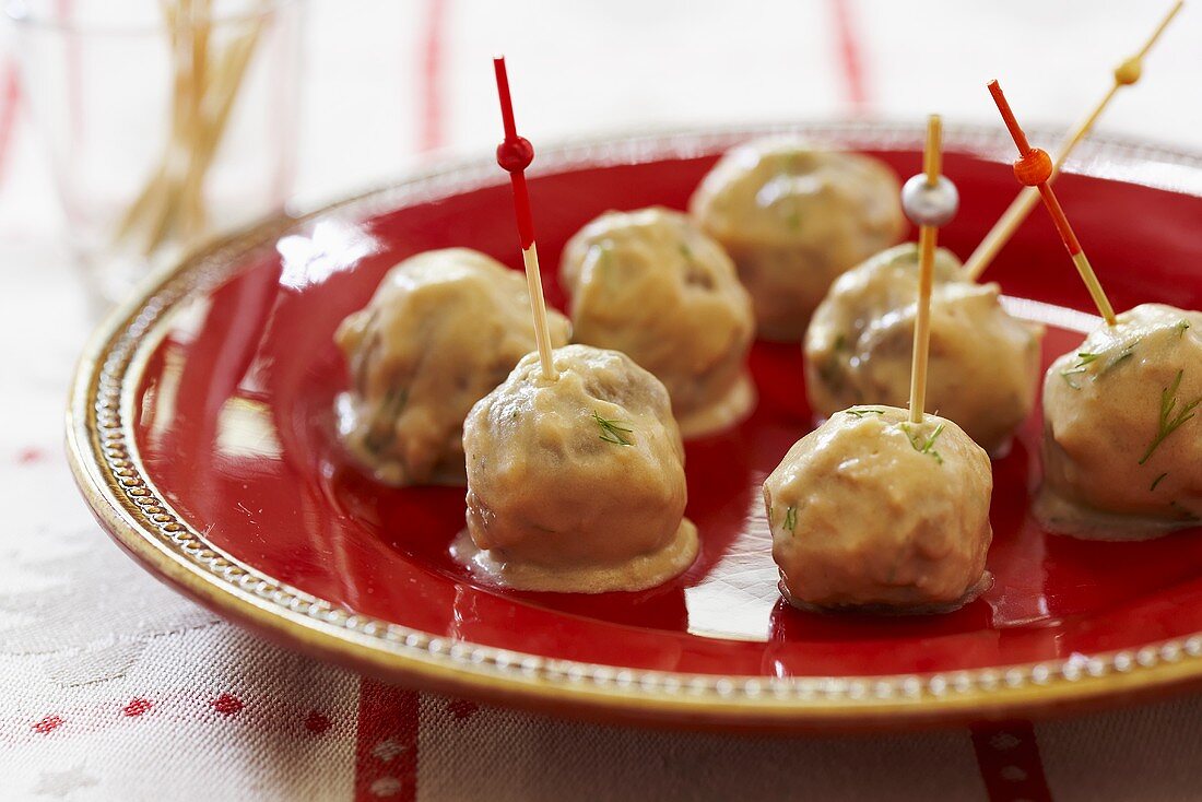 Swdish Meatballs with Toothpicks on a Red Dish