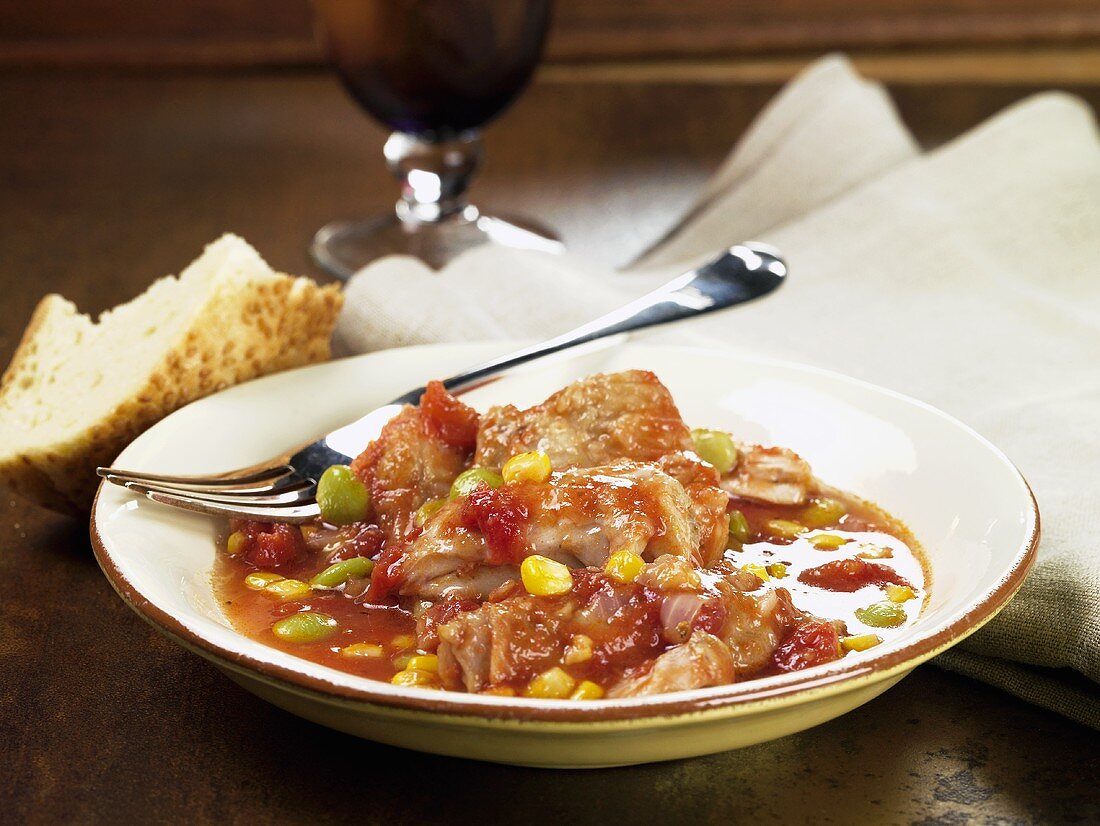 Chicken ragout with tomatoes, sweetcorn and peas
