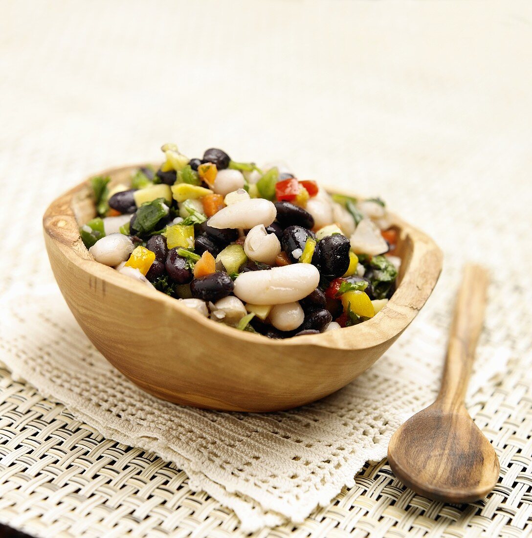 Bean Salad in a Wooden Bowl; Wooden Spoon