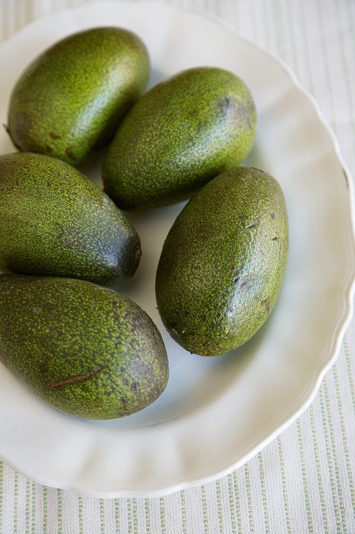 Fresh Whole Avocados on a Dish