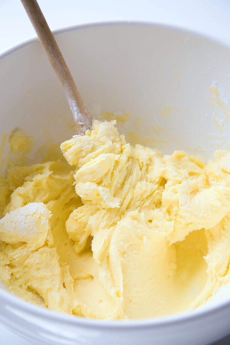 Bowl of Butter Icing with Wooden Spoon