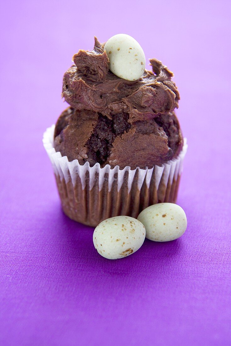 Chocolate Muffin Topped with Chocolate Frosting and Candy Egg