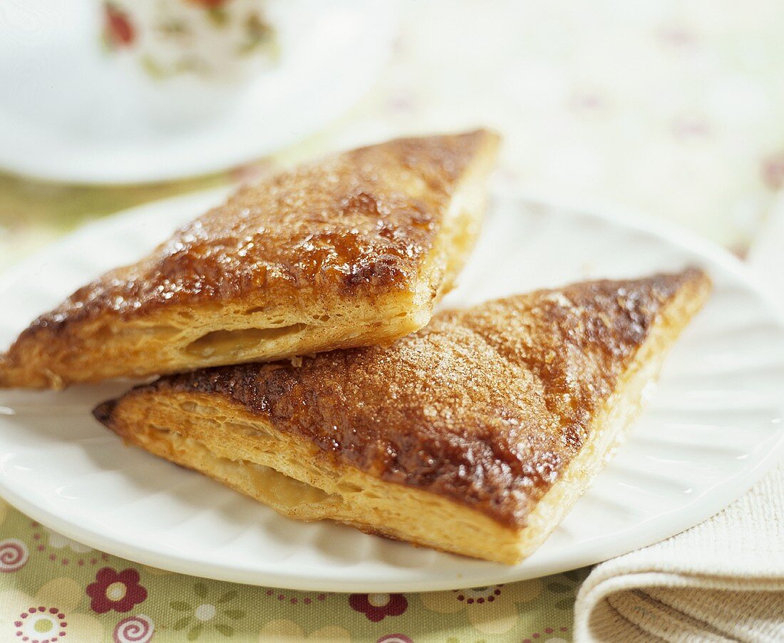 Two Apple Turnovers on White Plate