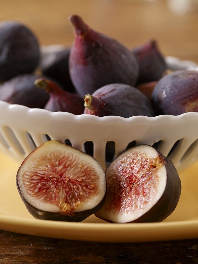 Halved Fig In Front of a Bowl of Figs