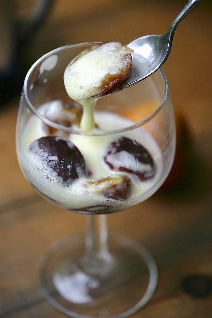 Plums and Cream Dessert; Spooning From Glass