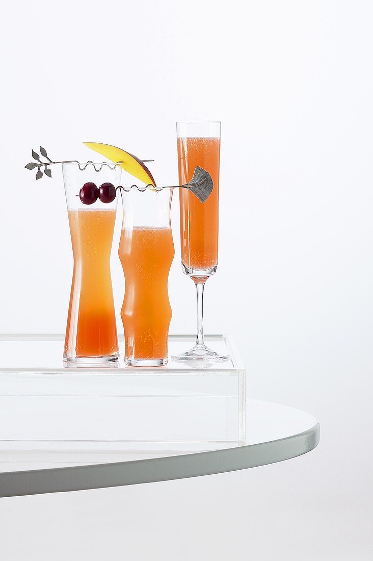 Three Fruity Cocktails in Tall Glasses