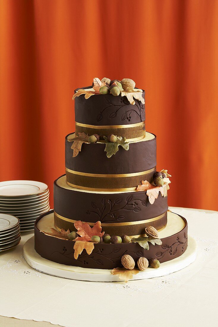 Brown Chocolate Wedding Cake Decorated with Fall Flowers and Nuts