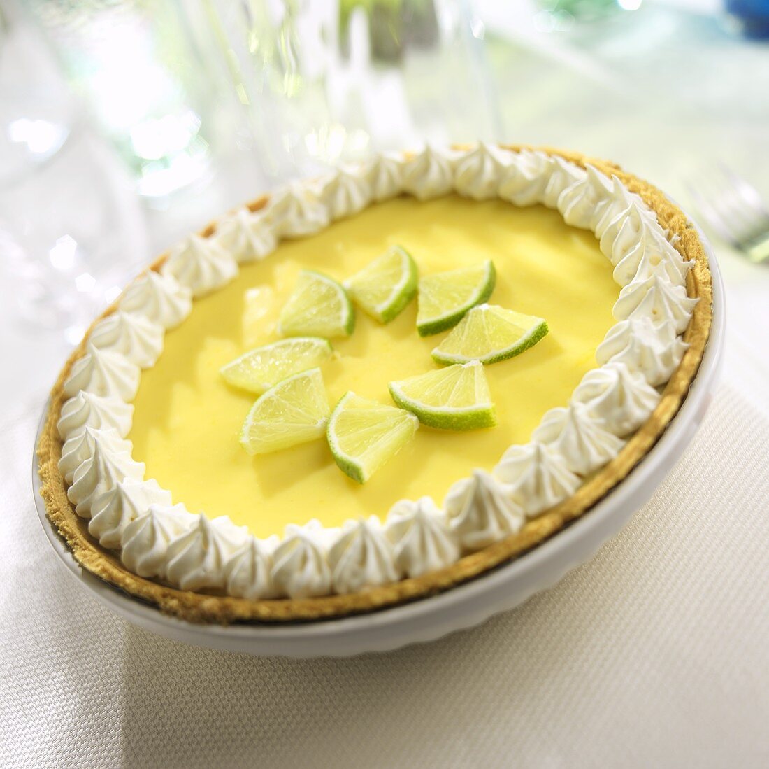 Key Lime Pie with Limes and Whipped Cream