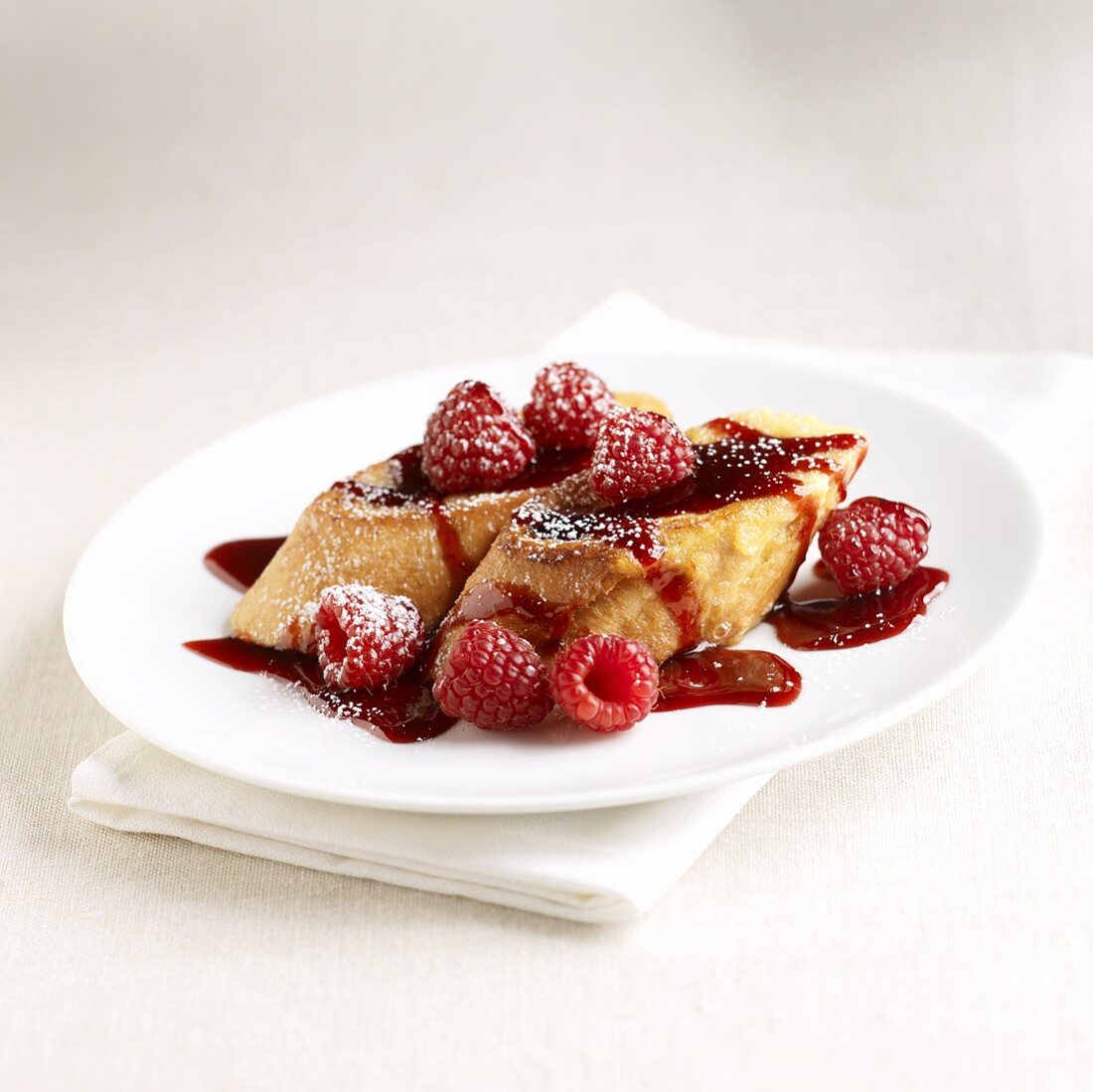 French Toast Topped with Raspberry Sauce and Raspberries