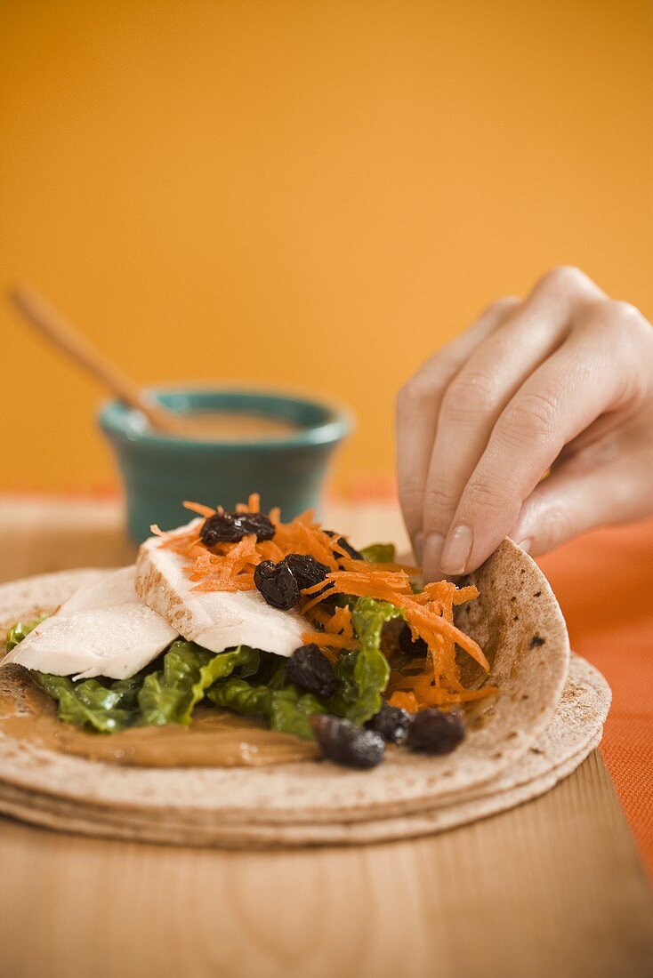 Hand Rolling Chicken and Vegetable Wrap