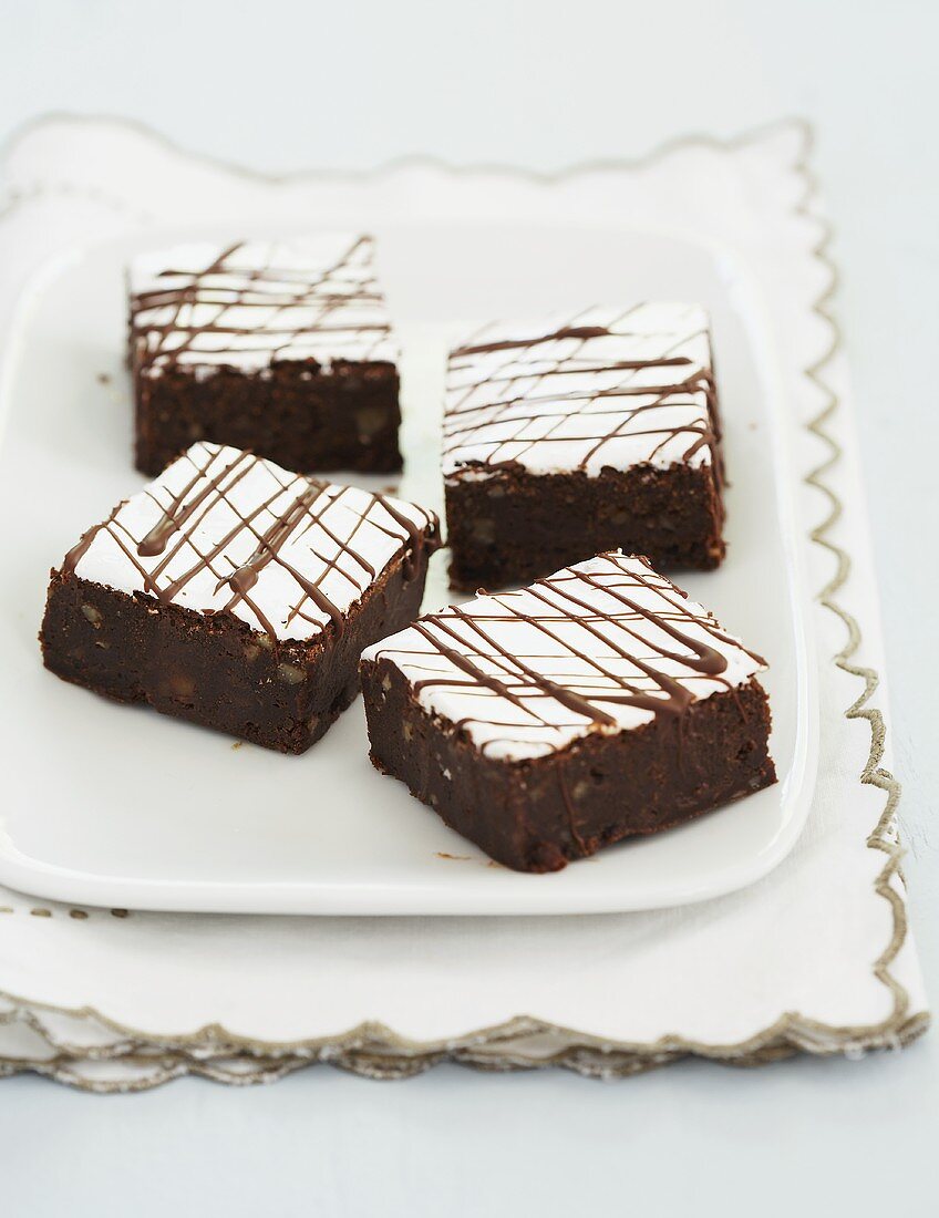 Four Frosted Mississippi Mud Brownies on a Plate