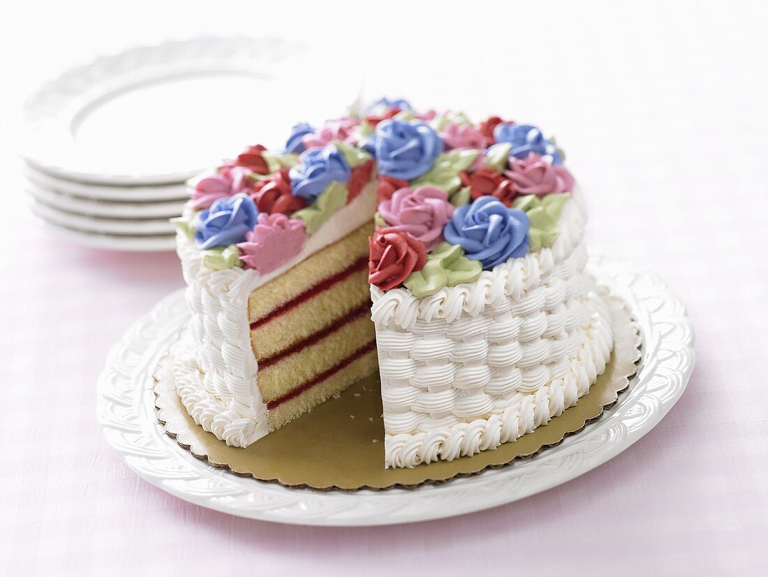 Festliche Sahnetorte mit Zuckerrosen, angeschnitten