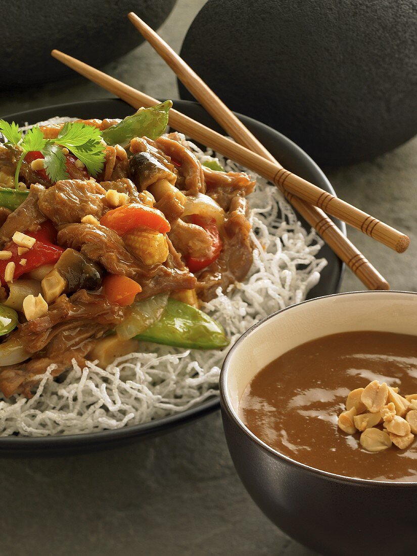 Pork and Vegetables in Peanut Sauce Over Noodles; Chopsticks