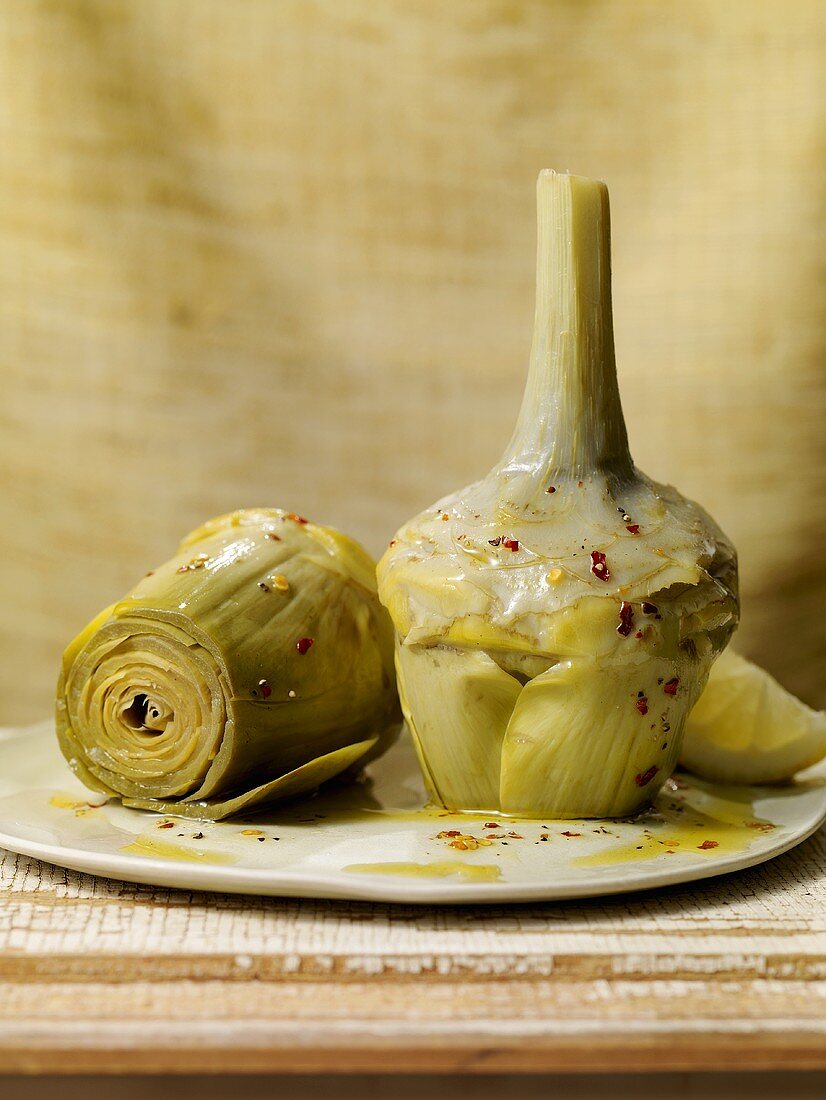 Steamed Artichokes on Plate with Herbed Olive Oil