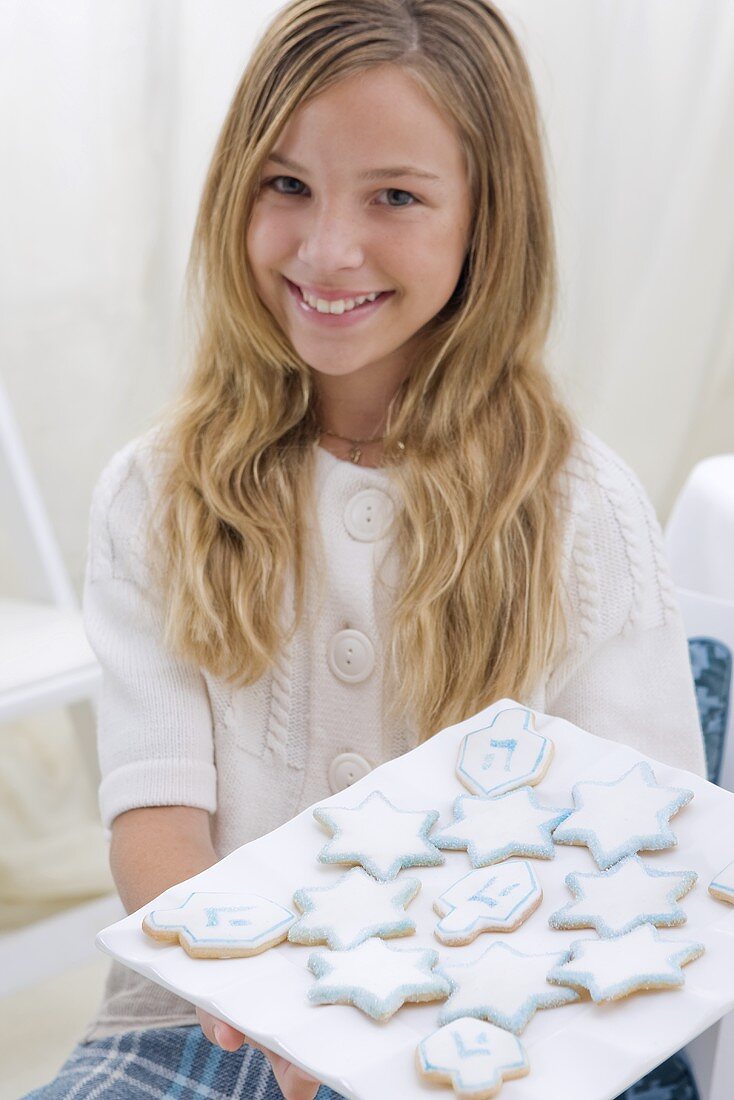 Young Girl Holding Platter of Chanukah Cookies