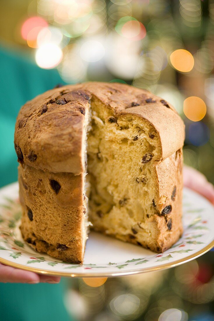 Woman Holding Panettone with Slice Removed