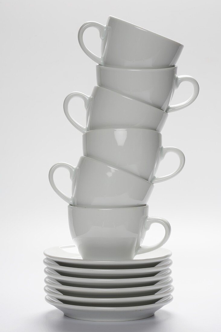 White Coffee Cups Stacked on Stacked Saucers