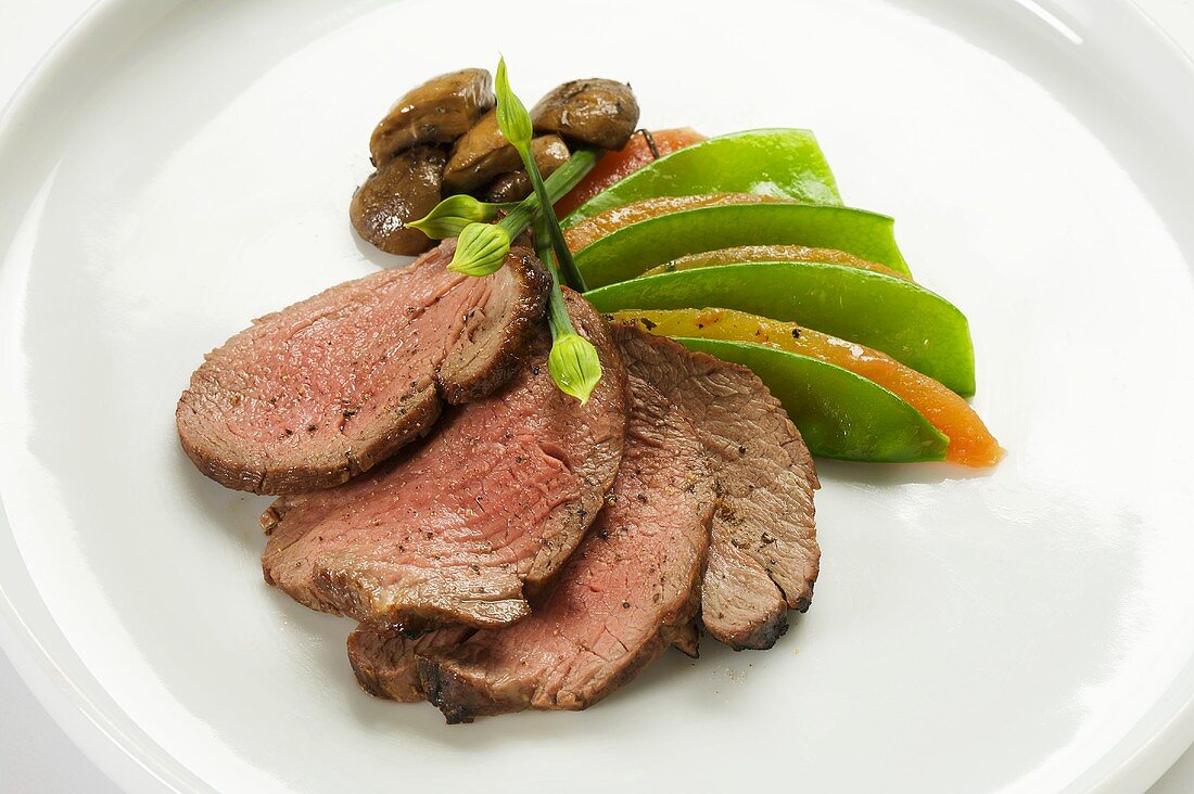 Sliced Beef with Pea Pods on White Plate