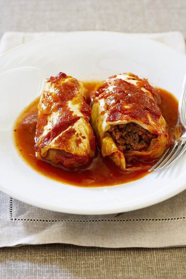 Two Stuffed Cabbage Rolls with Tomato Sauce on Plate