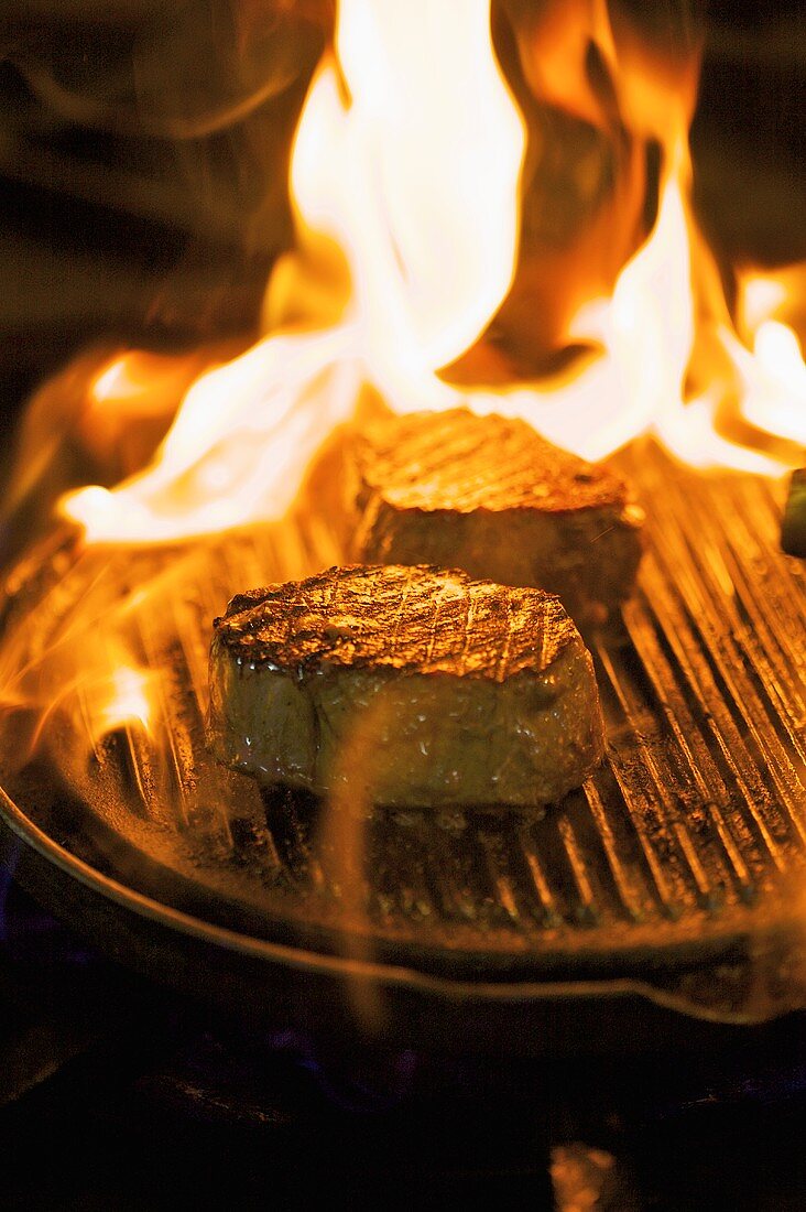 Two Steaks on Grill Pan; Flames