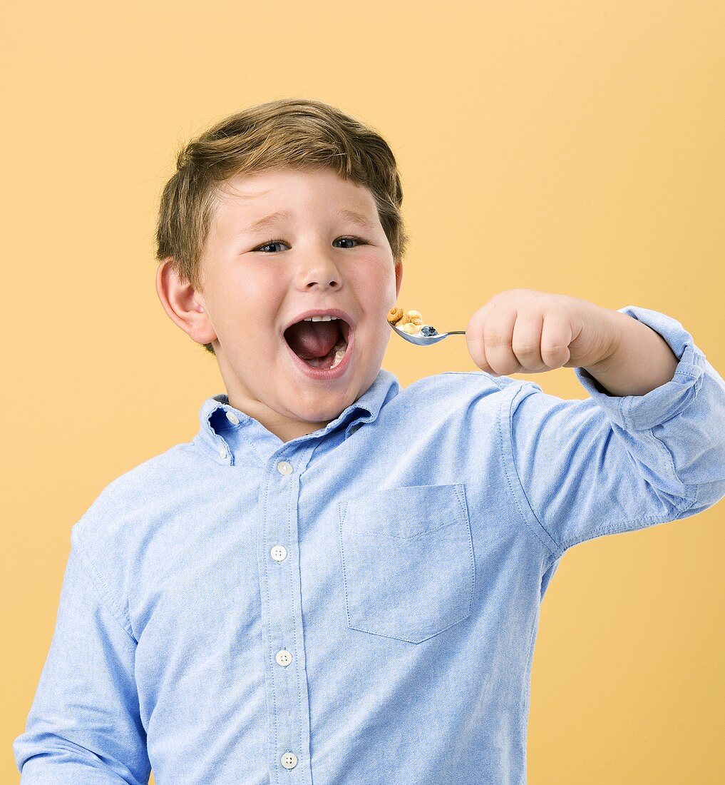 Little Boy Holding Spoonful of Cereal with Fruit