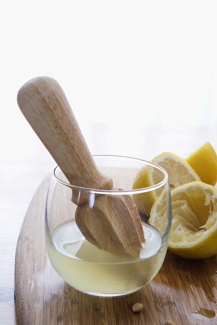Fresh Lemon Juice with Juicer and Lemons