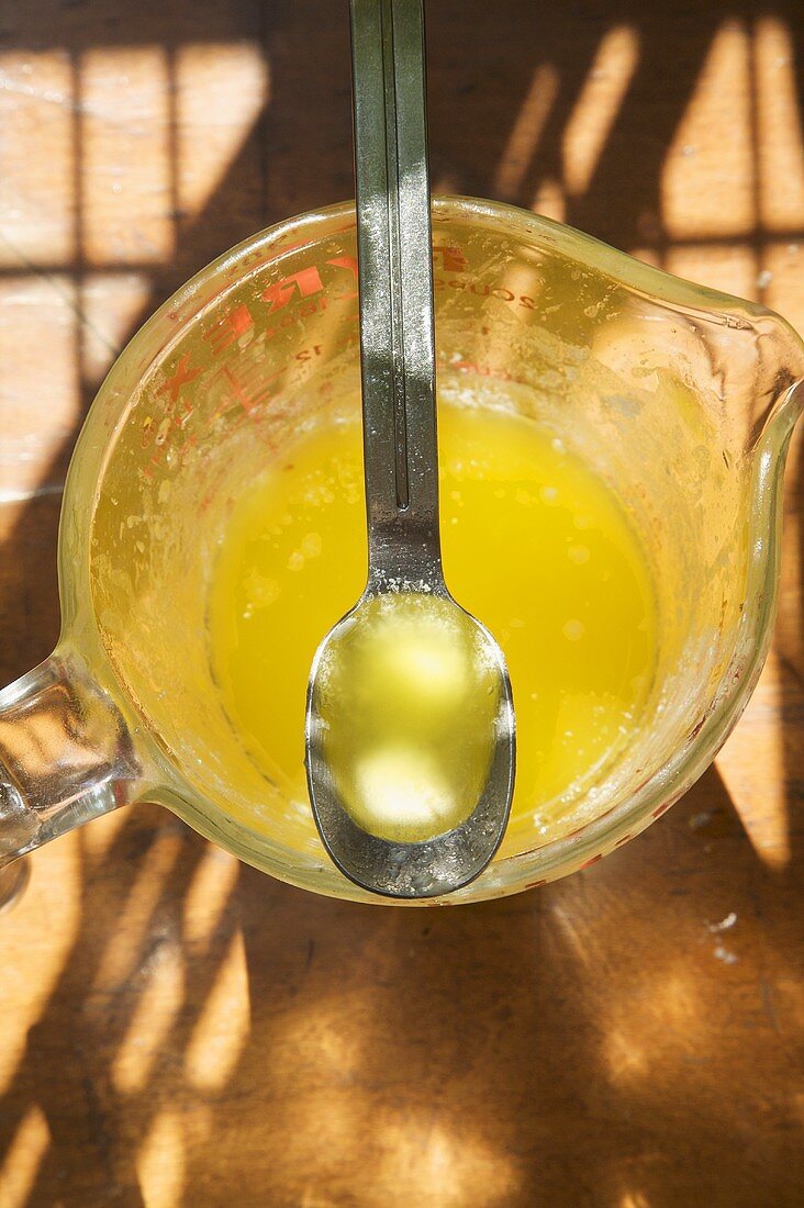 Melted Butter in Measuring Cup and Spoon