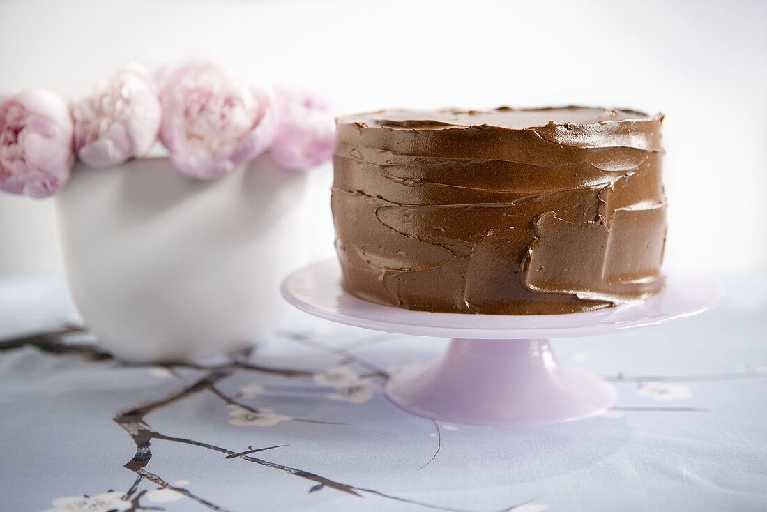 Chocolate Frosted Cake on Pedestal Dish; Pink Flowers