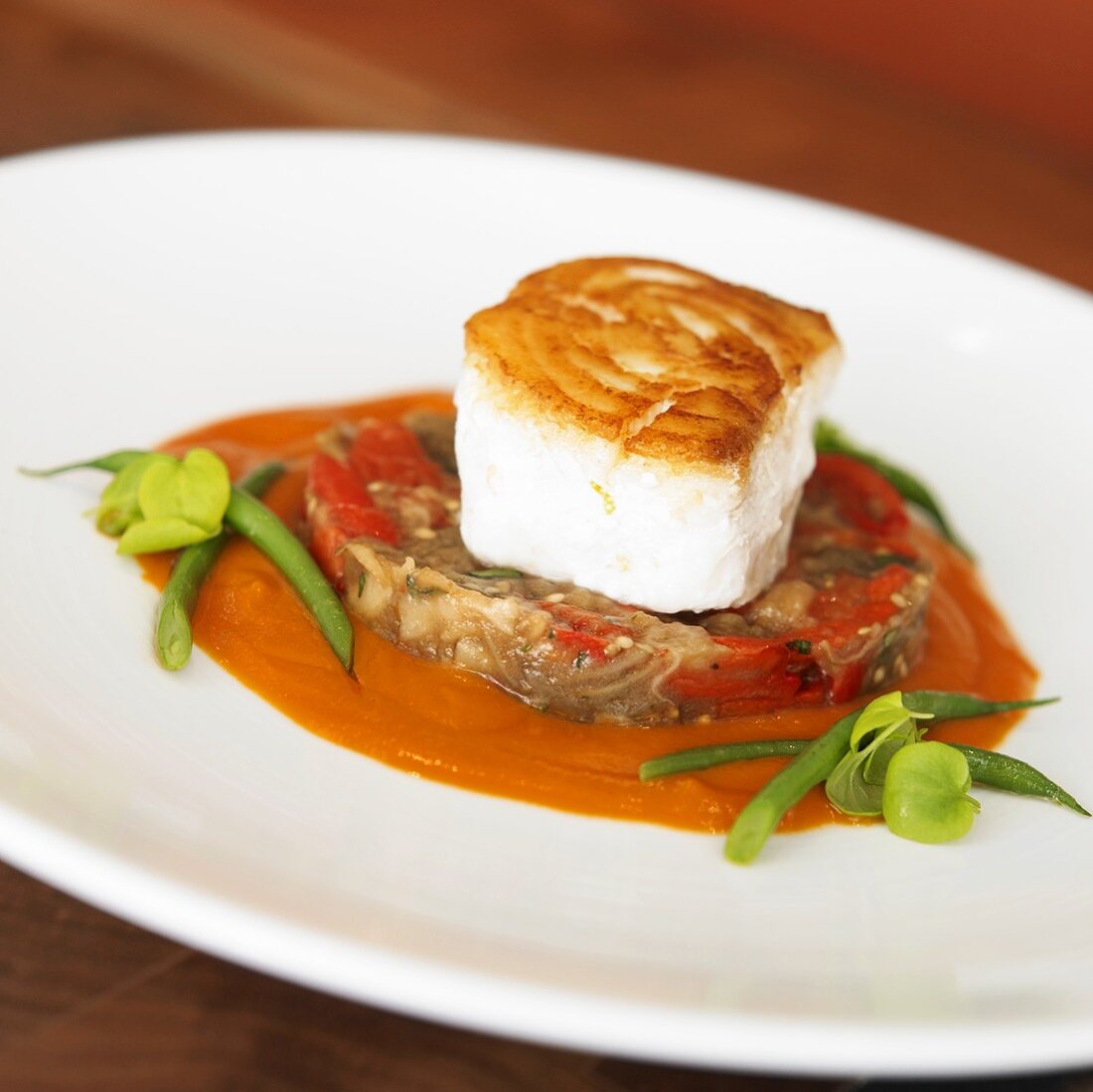 Seared Halibut atop Mixed Vegetable Patty with Tomato Sauce