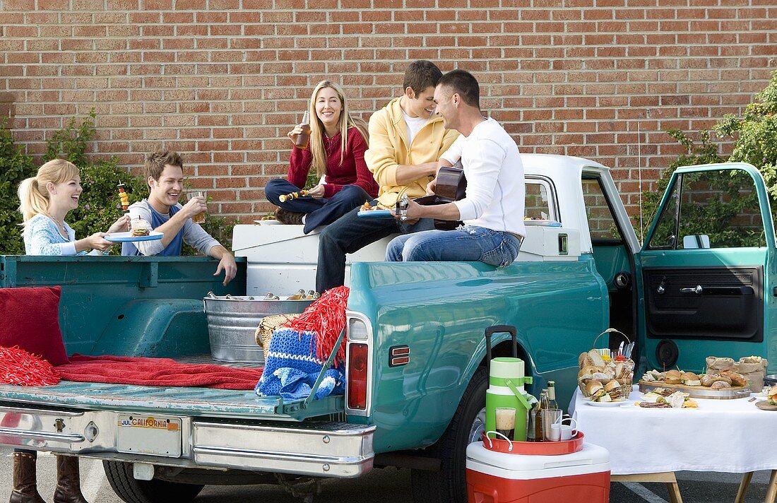 Friends Having a Tailgating Party in the Back of a Pickup Truck