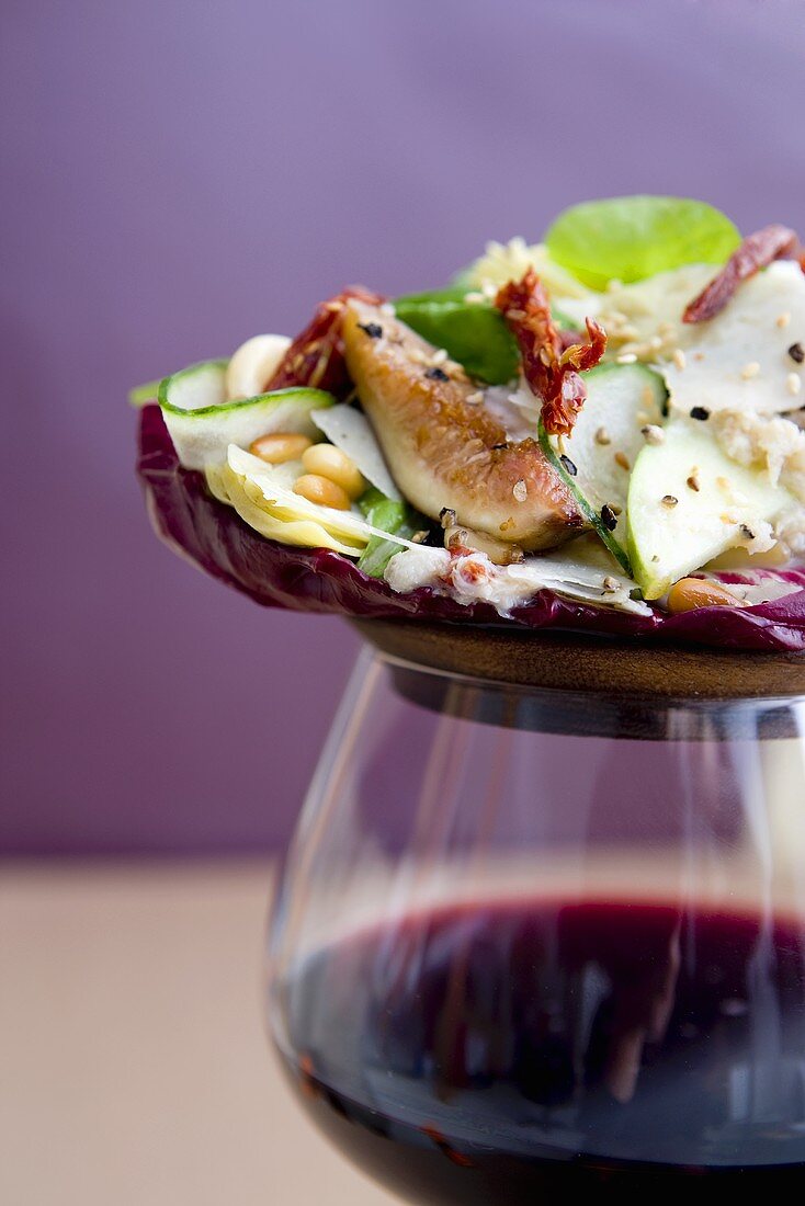 Salad of Figs, Pine Nuts and Sun Dried Tomato on a Glass of Wine