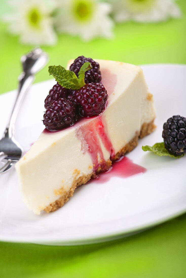 Piece of Cheesecake with Blackberry Topping and Mint