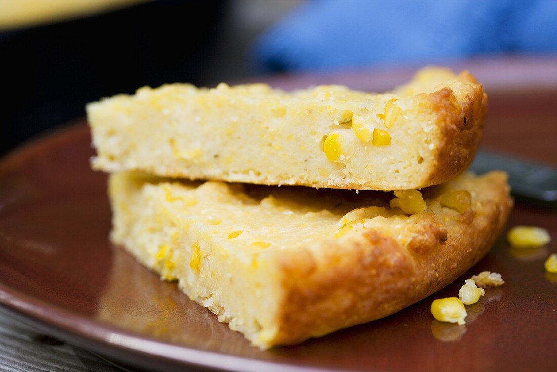 Two Pieces of Cornbread Cooked in Cast Iron Skillet