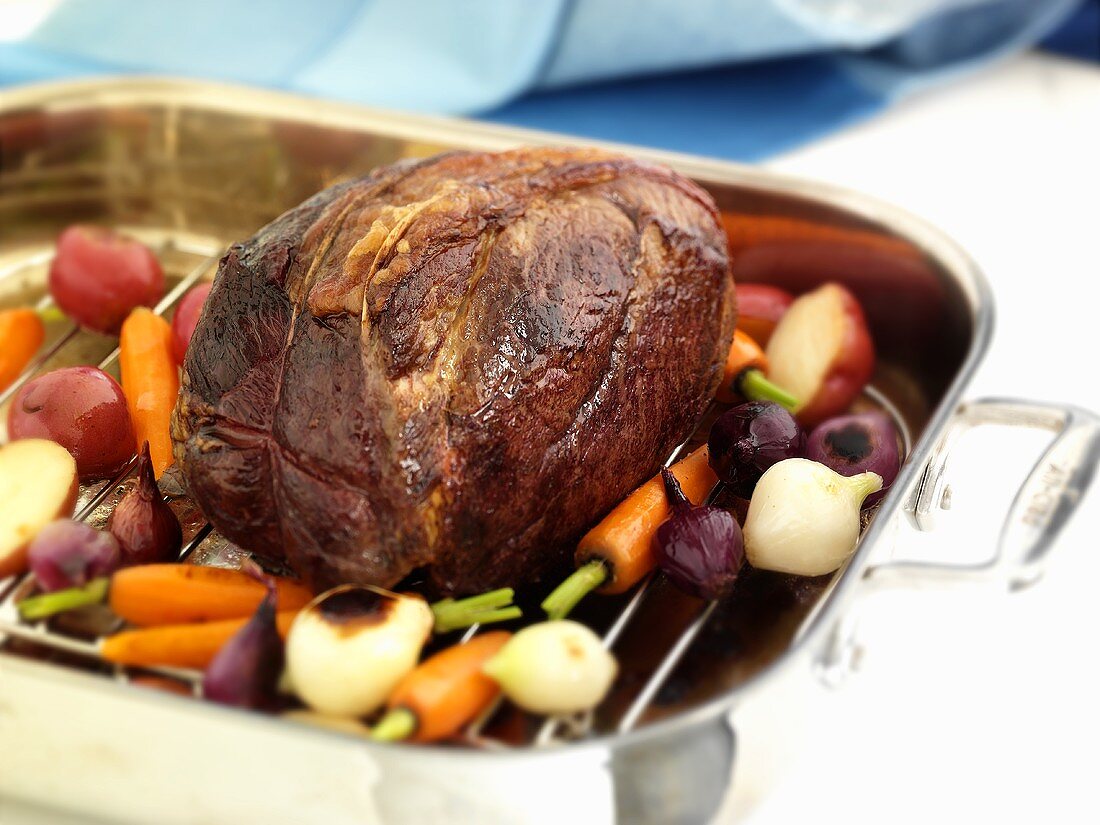 A Whole Chuck Roast in a Roasting Pan with Veggies