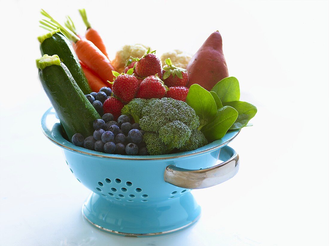 Blue Colander Filled with Fresh Picked Fruits and Vegetables