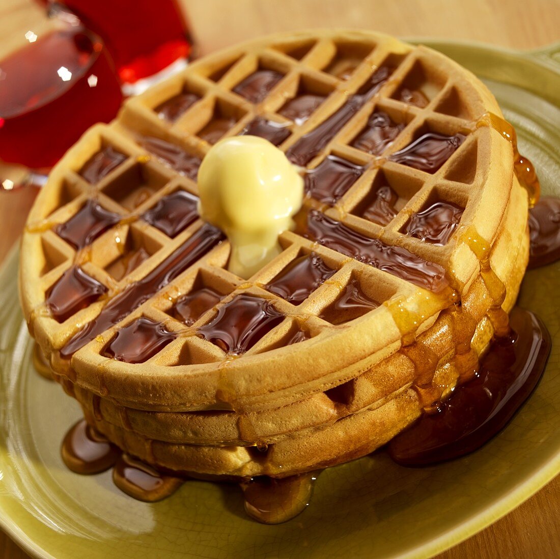 Stack of Three Waffles with Butter and Maple Syrup