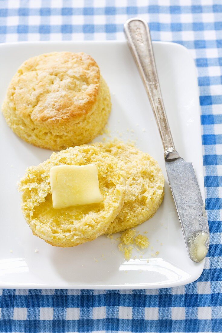 Cornmeal Biscuit Halved with Butter; On Plate with Biscuit
