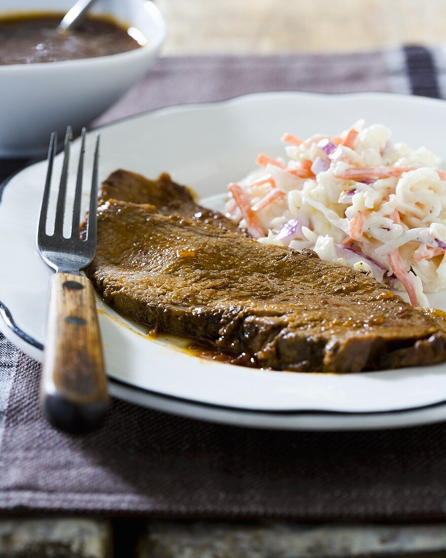 Slice of Brisket with Coleslaw on a Plate