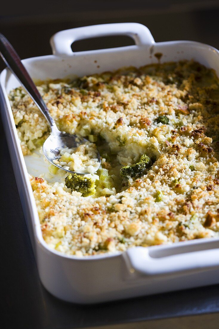 Broccoli Rice Casserole in Baking Dish with Scoop Removed