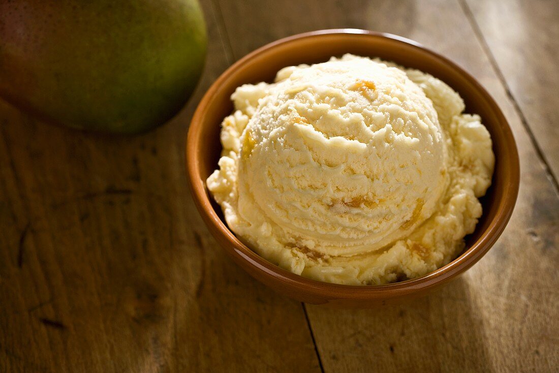 Scoop of Mango Ice Cream in a Bowl on Wooden Table