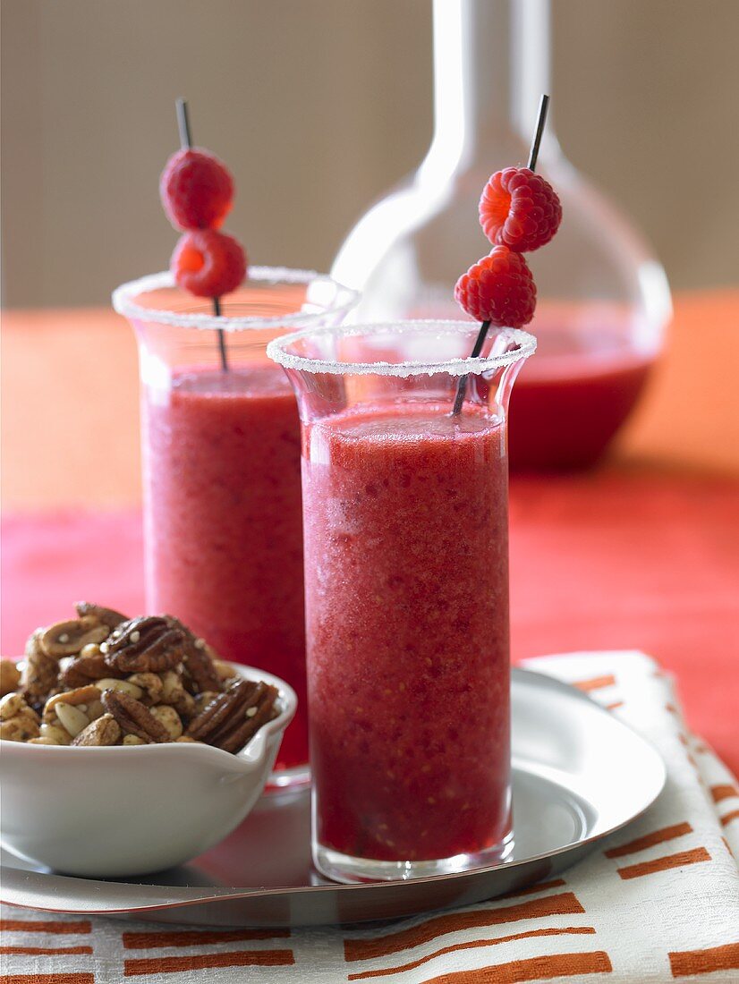 Frozen Raspberry Margaritas with a Bowl of Mixed Nuts